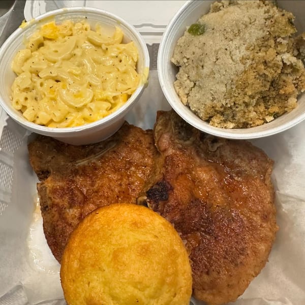 Marie's Soul Food pork chop meal with mac and cheese, dressing, and cornbread.