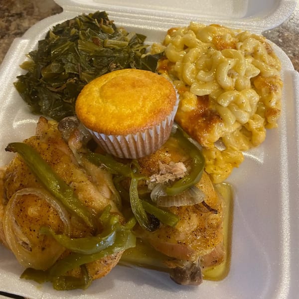 Marie's Soul Food take-out meal with baked chicken, collard greens, macaroni and cheese, and cornbread.
