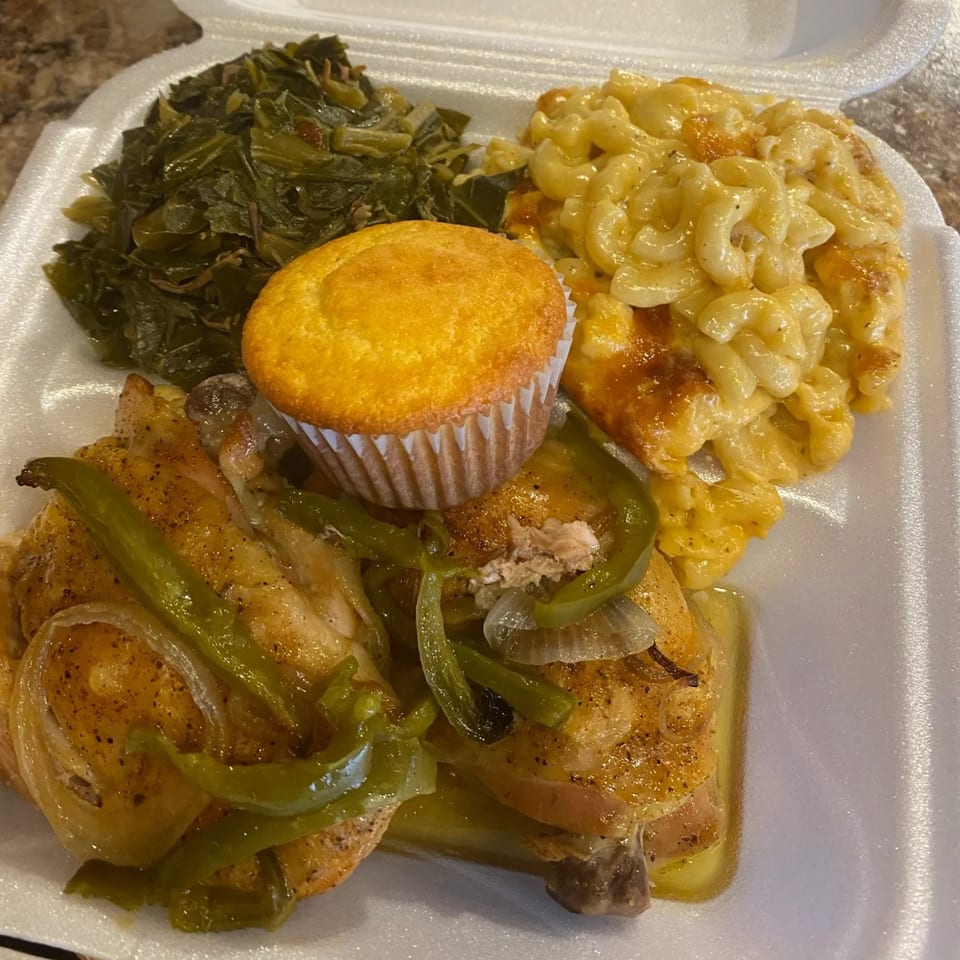 Marie's Soul Food take-out meal with baked chicken, collard greens, macaroni and cheese, and cornbread.